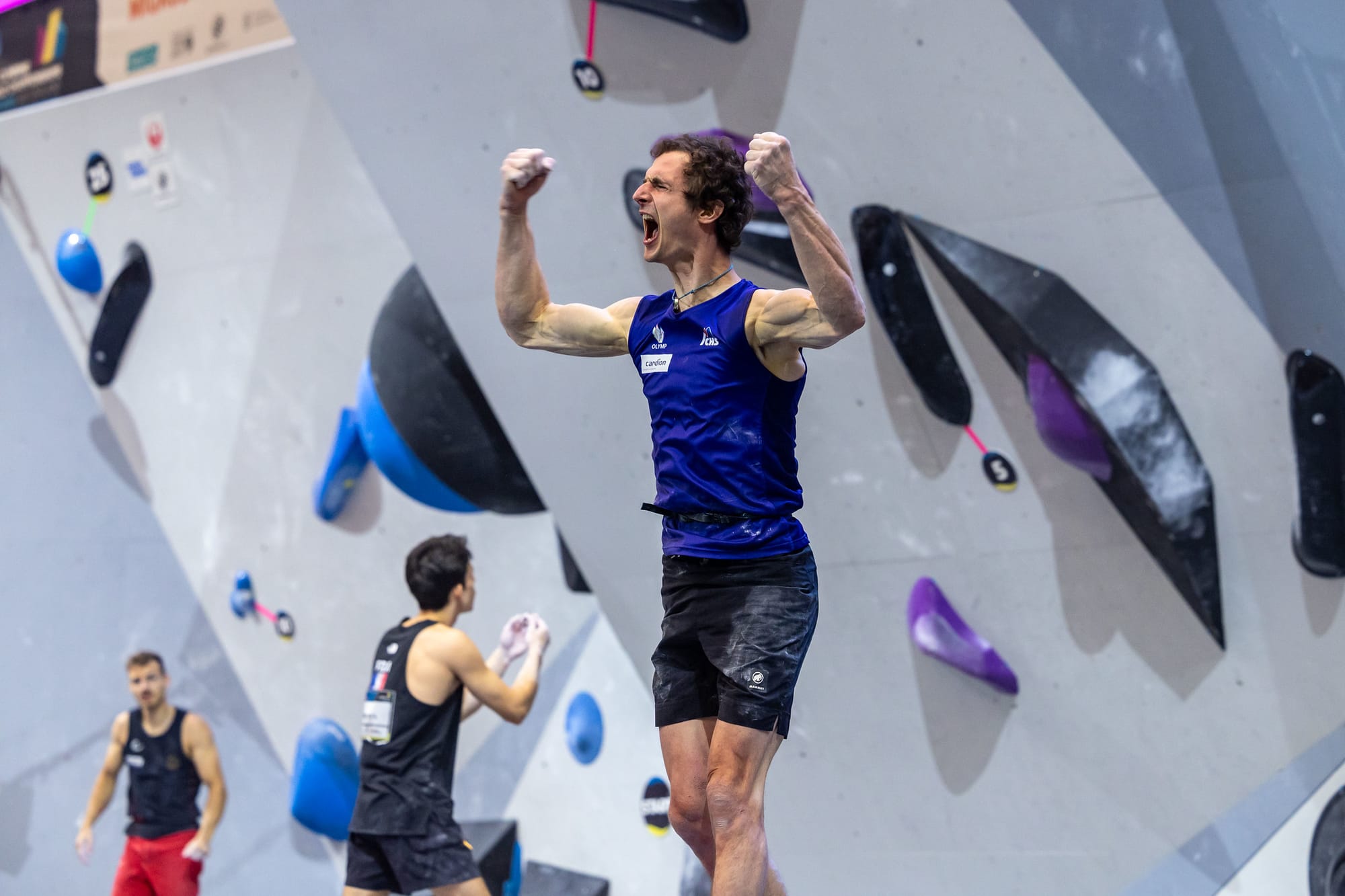 Adam Ondra celebrating topping a boulder in the Combined Semi-final Boulder round.