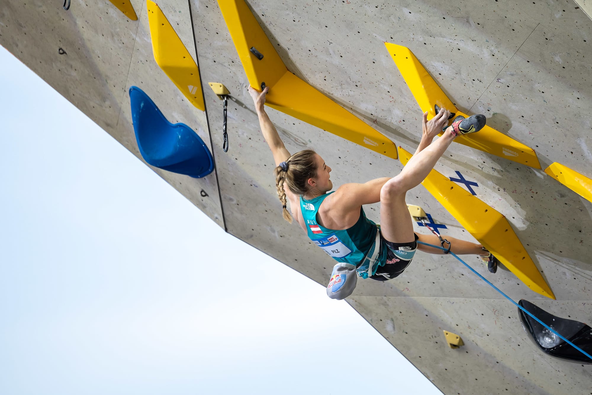 Jessica Pilz fighting to get a heel before reaching up for hold 25 on the Women’s Lead Route at the 2023 Lead World Cup in Innsbruck.