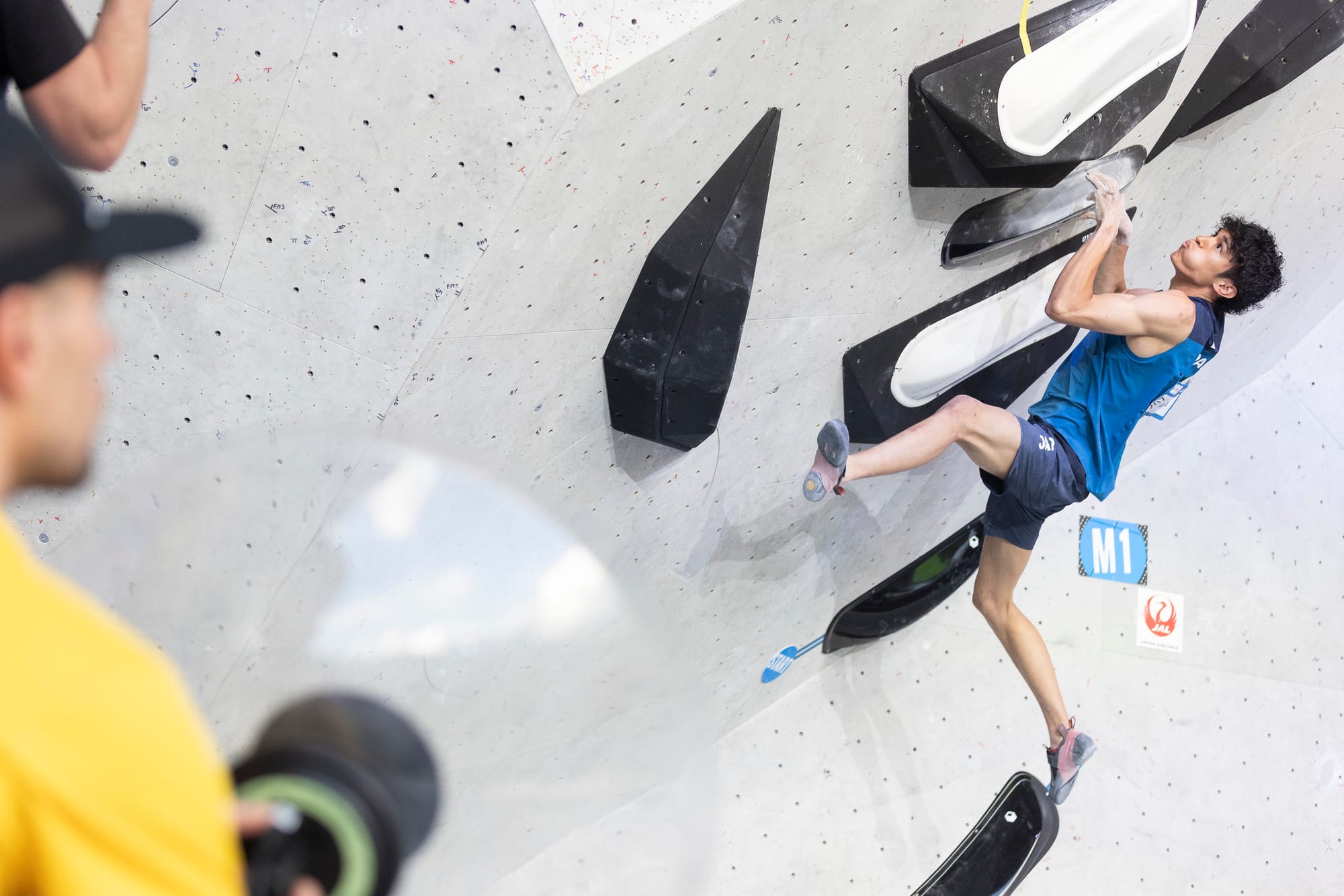 Meichi Narasaki on the first men's final boulder of the 2023 IFSC World Cup in Brixen, Italy.