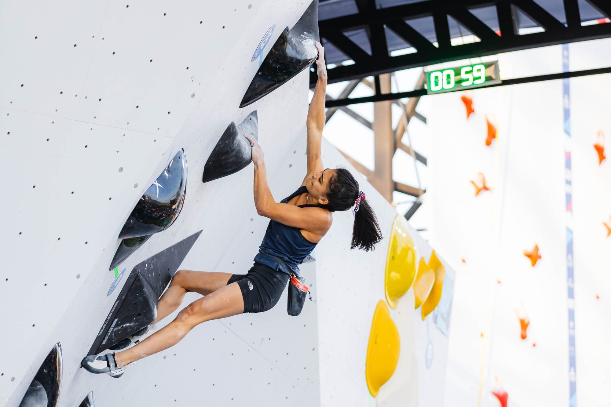 Natalia Grossman tickling the top hold before falling off Boulder 4