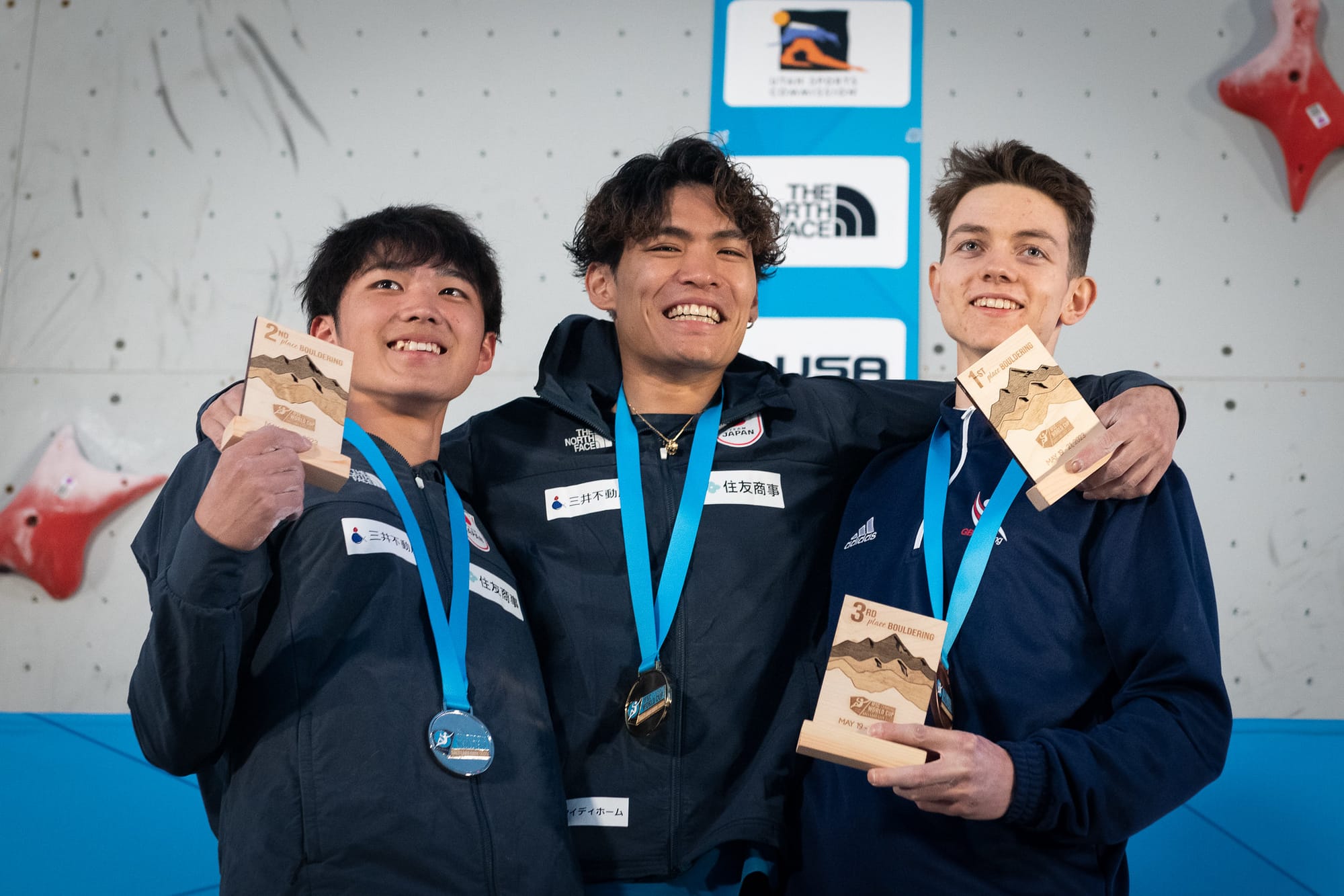 Tomoa Narasaki, Sorato Anraku, and Toby Roberts celebrating with their 2023 SLC World Cup medals